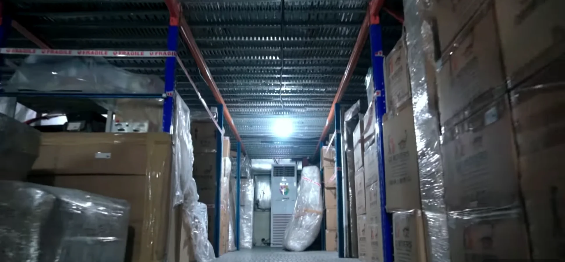 Secured and wrapped goods stored on warehouse racks ready for inter-emirate moving from Dubai