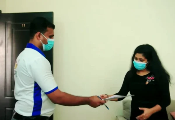 Movers and packers staff presenting moving cost estimate to customer in Dubai apartment